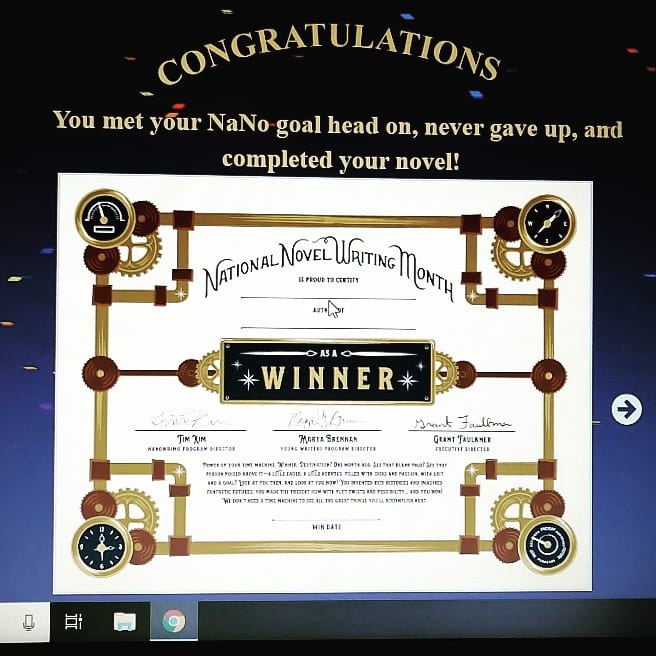 A photograph of the NaNoWriMo winner's certificate, as displayed on my laptop screen. Text reads: "You met your NaNo goal head on, never gave up, and completed your novel!"